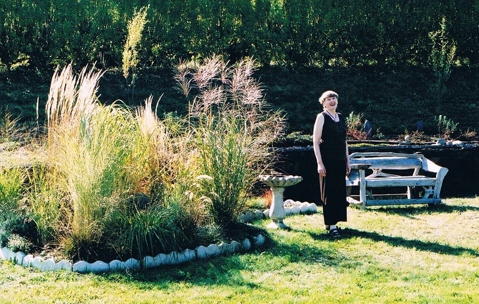 Garden bed of ornamental grasses with June Maginley