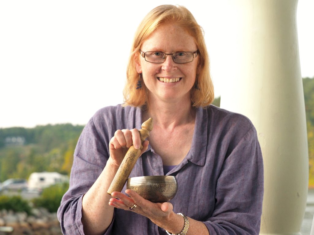 Pamela playing small brass singing bowl