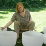 Pamela Holm with singing bowls oudoors in a park
